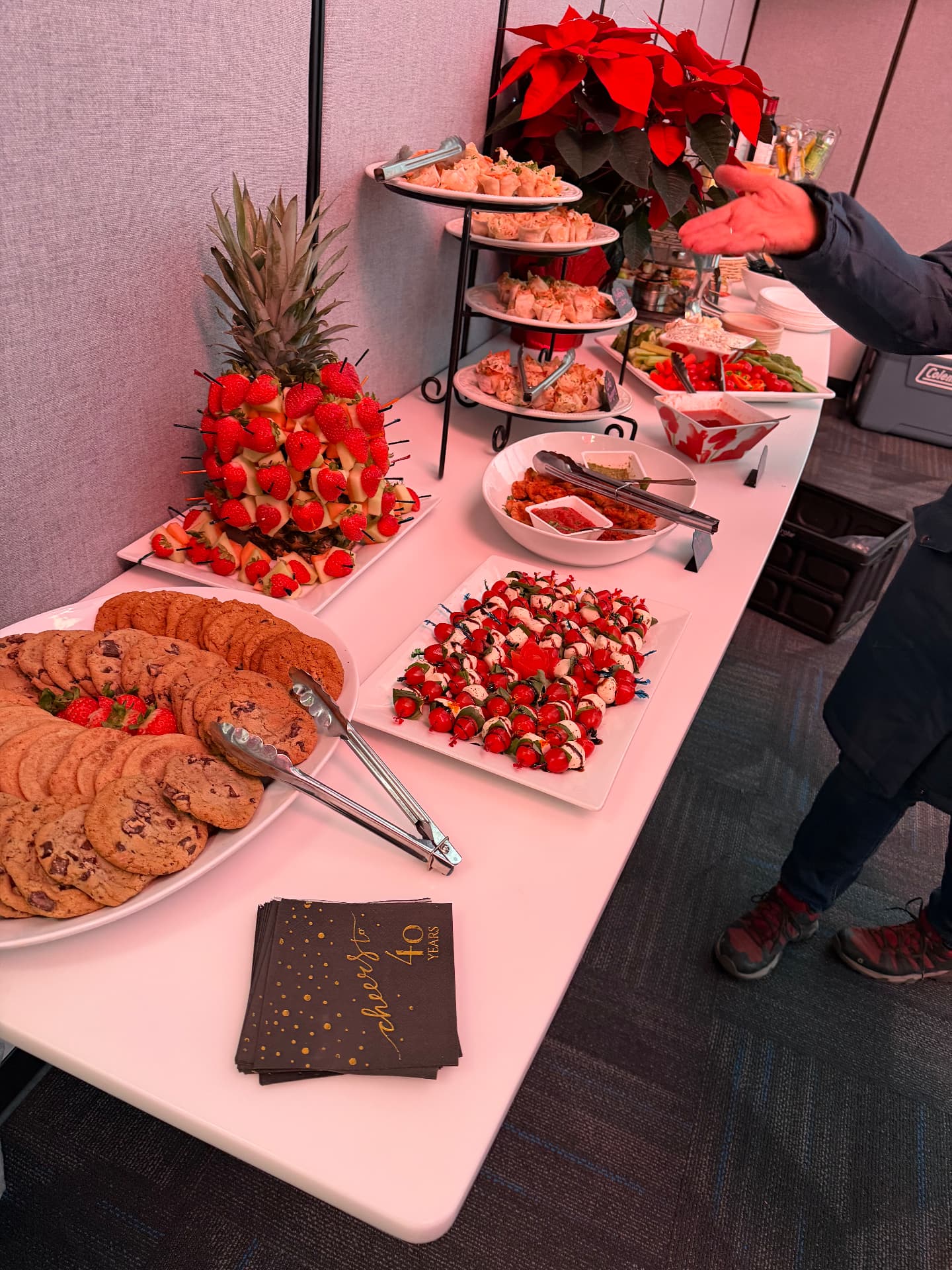 Holiday party spread with pineapple fruit tower and cookies