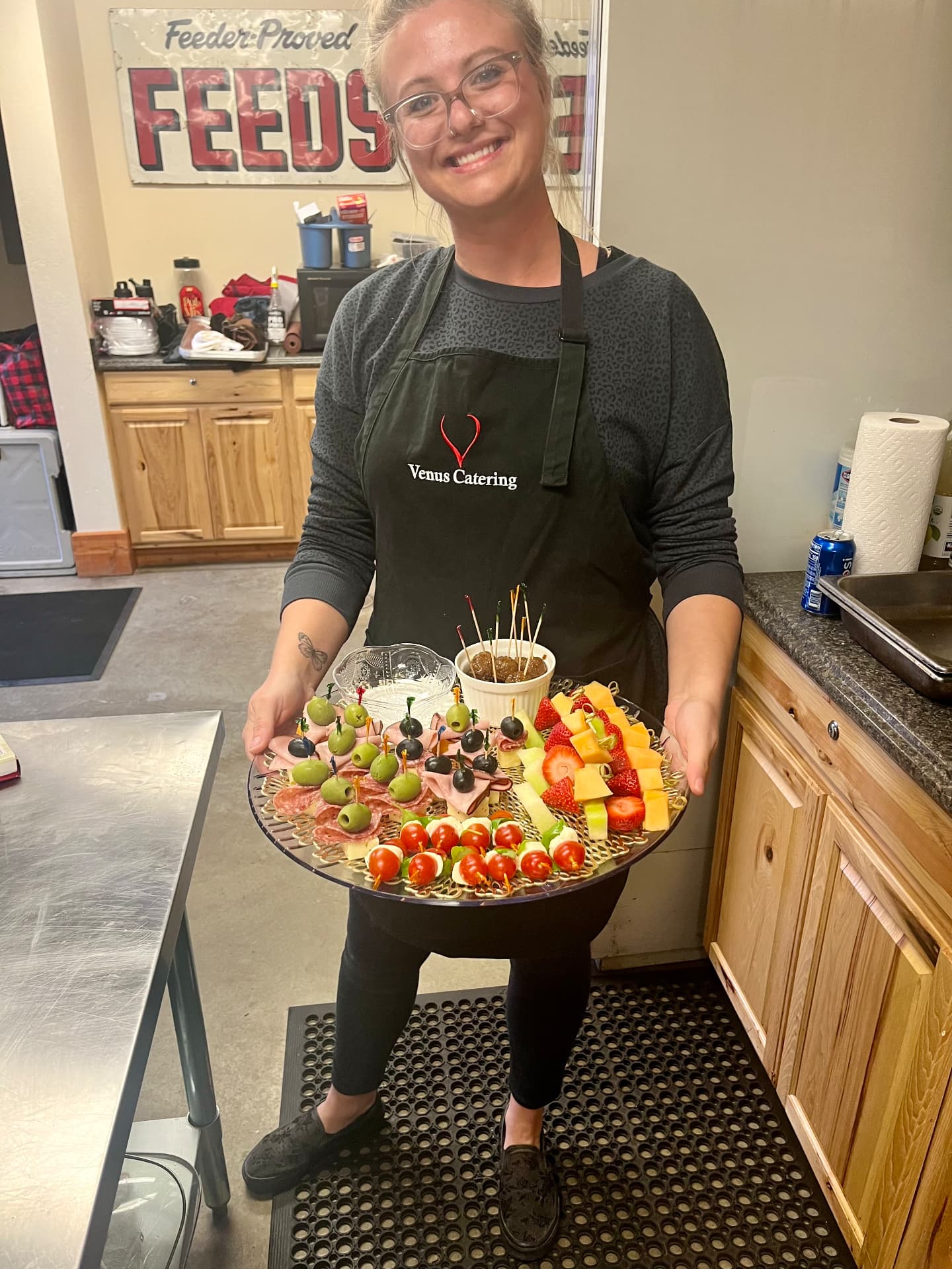Venus Catering crew member holding a tray of skewered appetizers