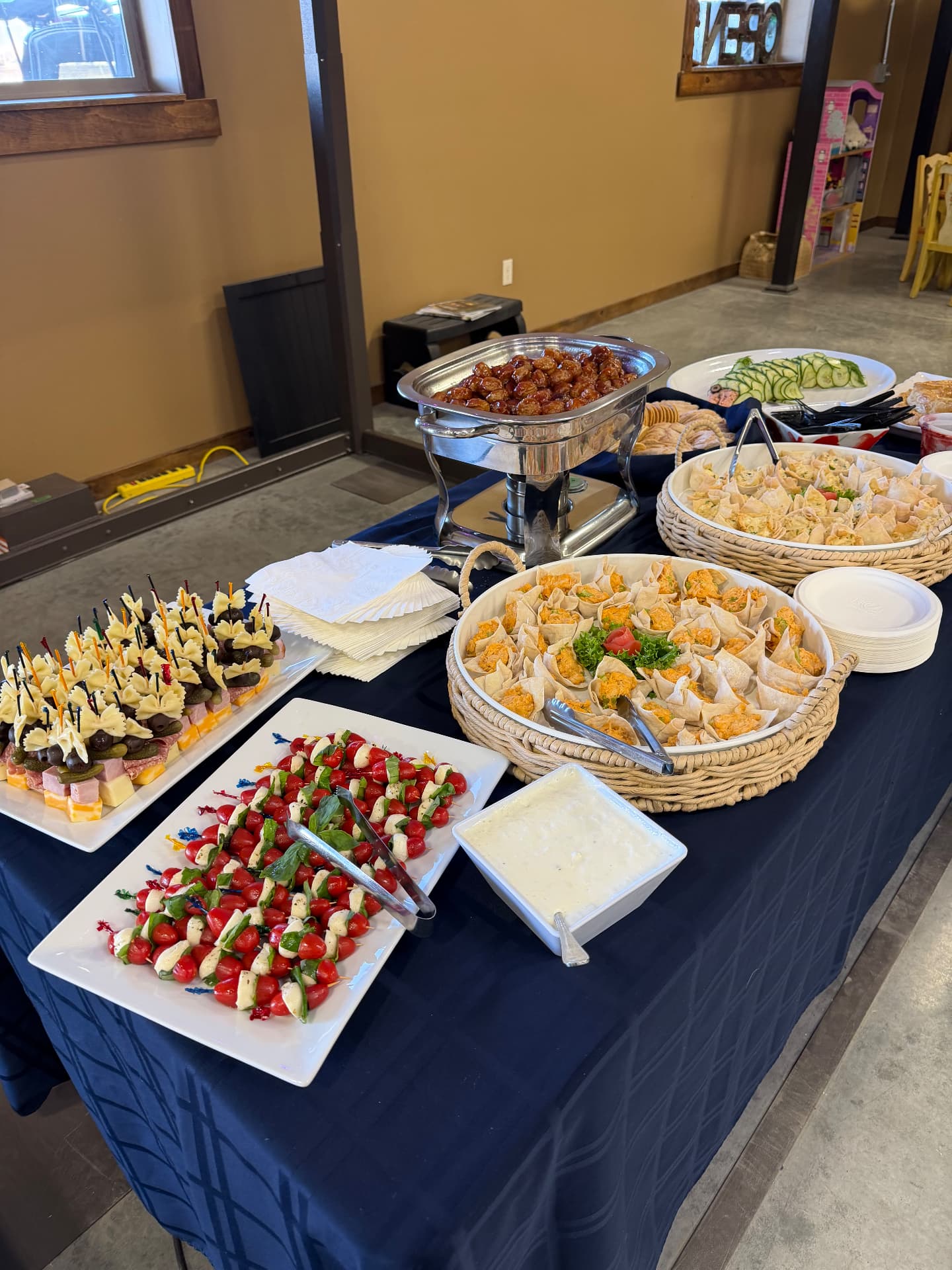Appetizer buffet with caprese skewers, wonton cups and meatballs